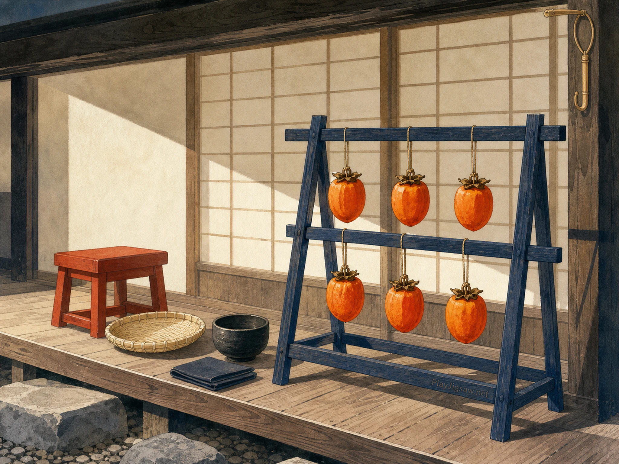 Six orange persimmons drying on an indigo wooden rack on a quiet Japanese veranda with vermilion stool, woven tray, tea bowl, and burned maker mark