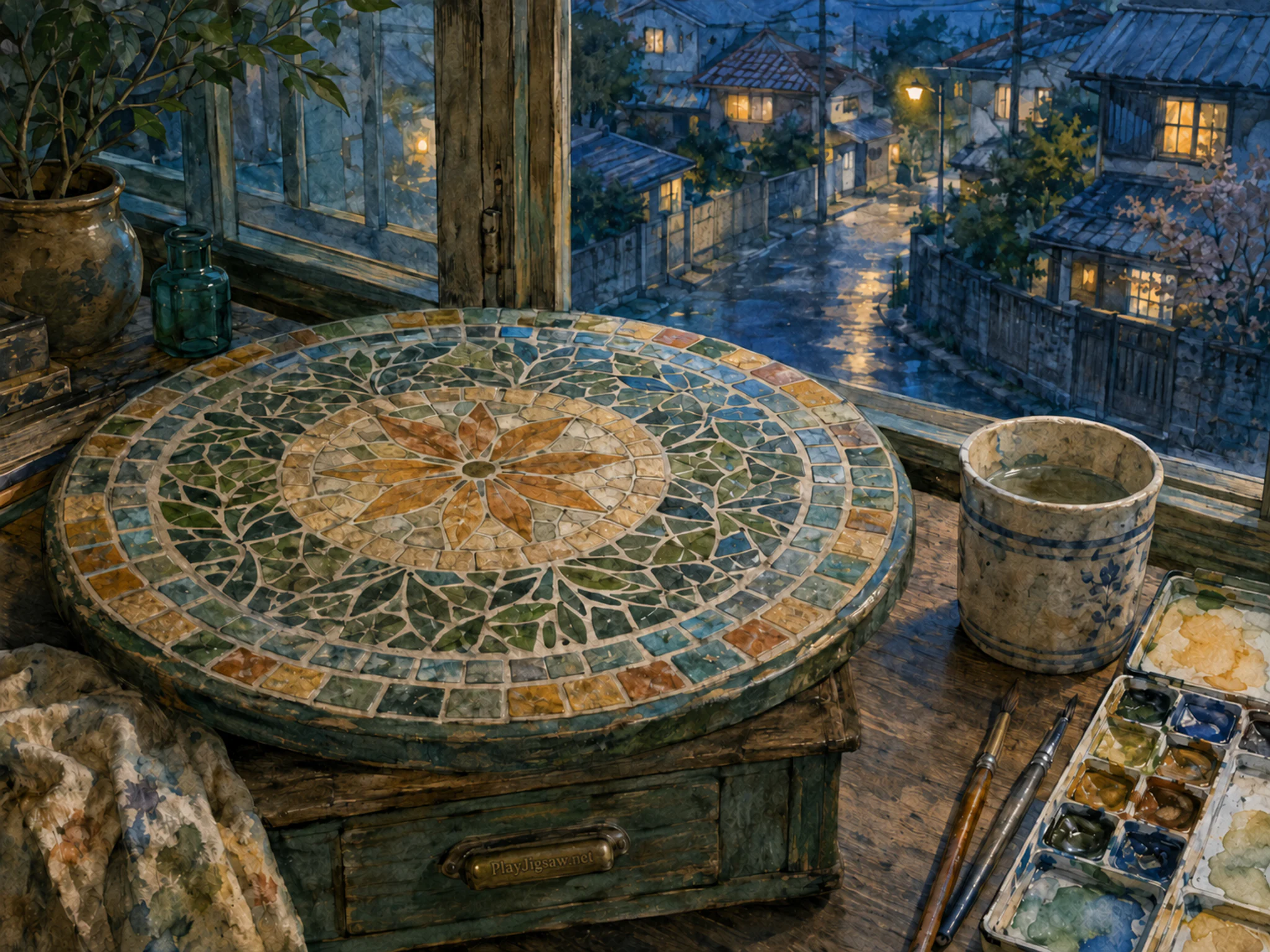 mosaic courtyard table arranged naturally beside a ceramic rinse cup in a window-side painting table overlooking a residential lane, with familiar objects and cool blue-hour light.